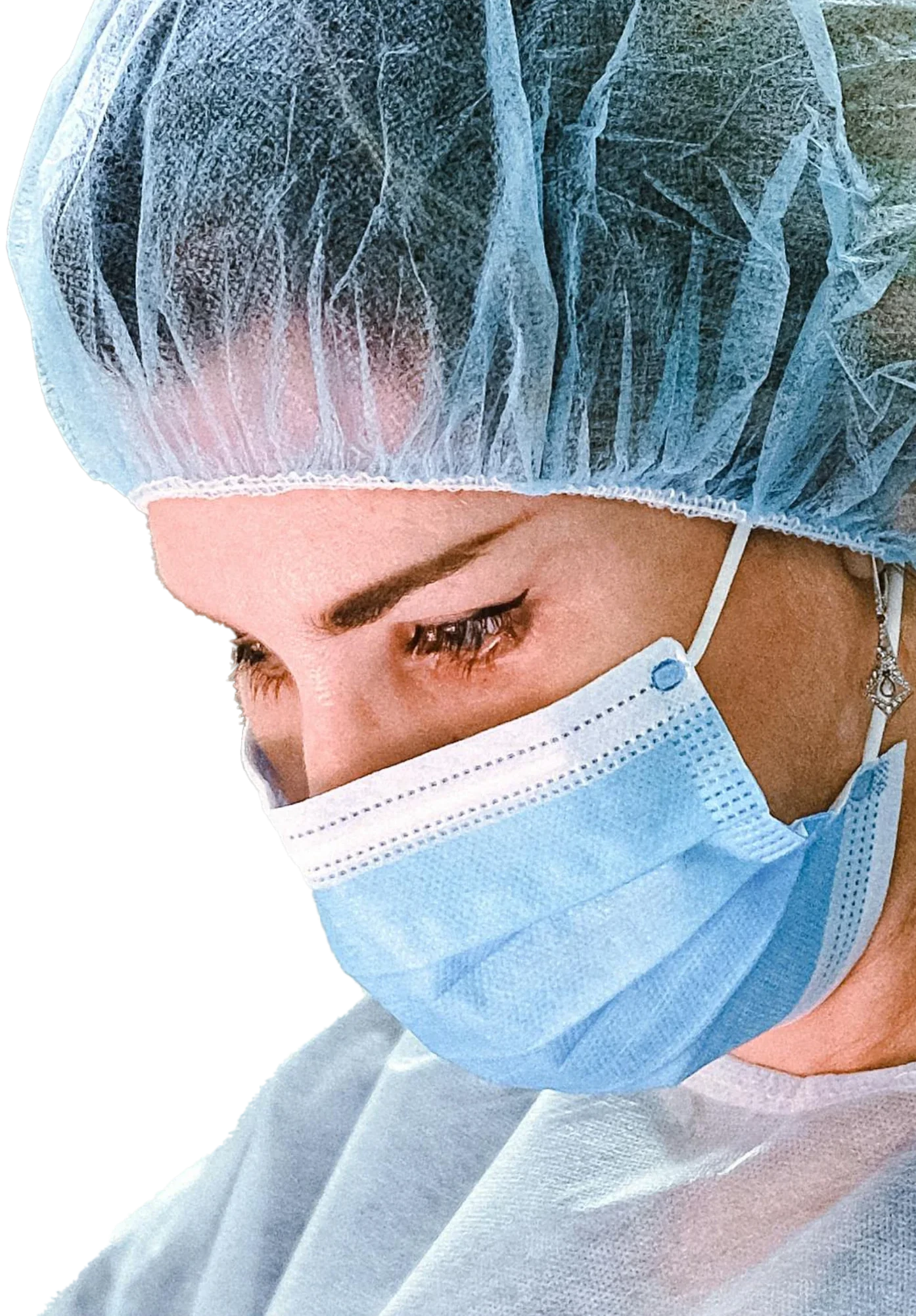 A clinician in a surgical cap and mask